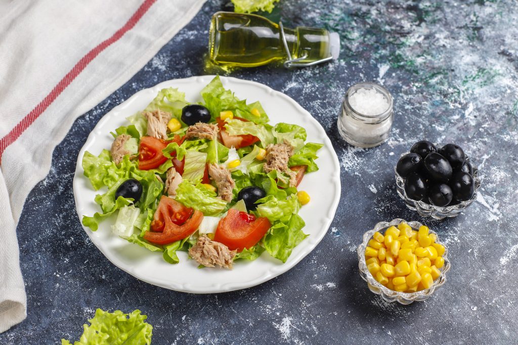 tuna salad with lettuce olives corn tomatoes top view scaled