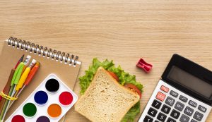 top view back school supplies with calculator sandwich scaled