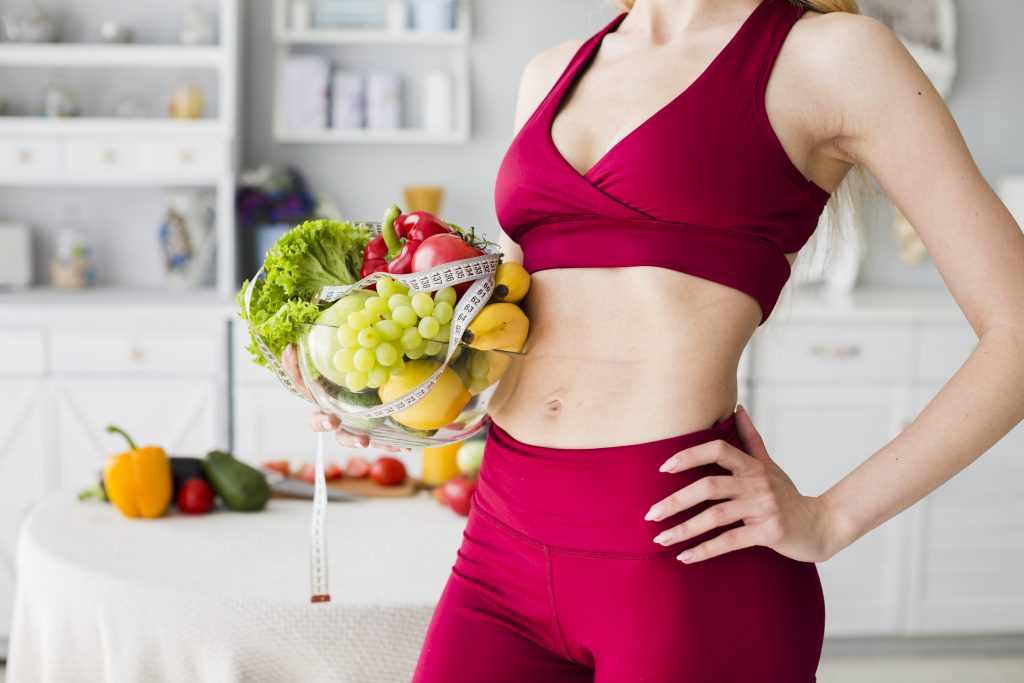 diet concept with sporty woman kitchen scaled
